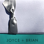 Joyce and Brian: thermography printed with pocket folder and silver band with wood grain texture