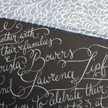 Christa and Lawrence: wedding invitation featuring custom calligraphy in white foil on 2 ply charcoal card stock and envelope liner in pewter with white floral pattern
