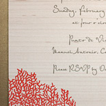 Monica and Alexander: invitation featuring coral design on wood with gold liner