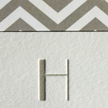 Ashley and Daniel: art deco font in taupe on a pearl white paper with chevron envelope liner