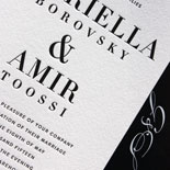 Gabriella and Amir: a modern, urban wedding invitation suite featuring black letterpress with a gold foil bar and white ink hand calligraphy